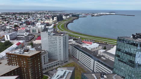 Drone-Shot-of-Reykjavik,-iceland,-Apartment-Buildings-and-Coastal-Street-Traffic-60fps