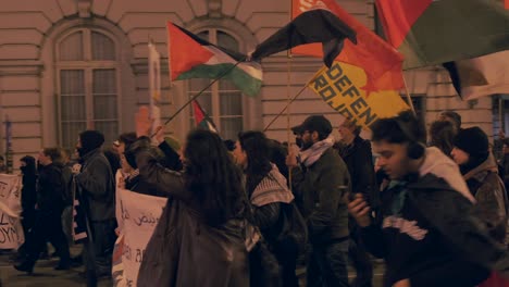 Women-leading-a-pro-Palestine-night-protest-with-flags