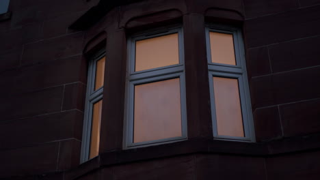 Red-brick-house-windows-closeup,-exterior-at-night