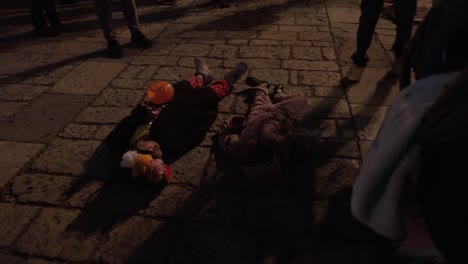 Children-lying-on-tourist-street-in-Oaxaca-to-ask-for-candy-for-Halloween-and-Day-of-the-Dead