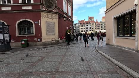 Strolling-by-the-Simonettich-tenement-house-nestled-on-the-corner-of-Warsaw's-Old-Town-Square-in-Poland