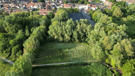 Tilt-Down-Aerial-View-on-Pathway-Through-Natural-Reserve-of-Bourgoyen-Ossemeersen,-Ghent,-Belgium