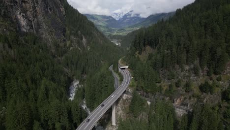 Panning-down-looking-at-bridge-over-river-in-San-Bernardino-valley,-Switzerland