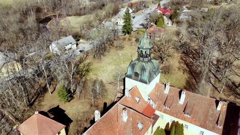 Lielstraupe-castle-tower-and-building-from-above-in-sunny-day,-Latvia