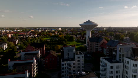 Örebro-skyline-and-iconic-water-tower-Svampen,-in-Sweden,-aerial,-evening