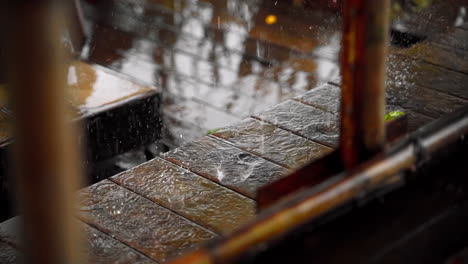 Close-Up-of-Rain-Drops-on-Wooden-Bench-in-Slow-motion