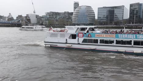 Terrible-River-Thames-Boat-Cruise-Sailing-Past-With-City-Hall-Building-In-Background