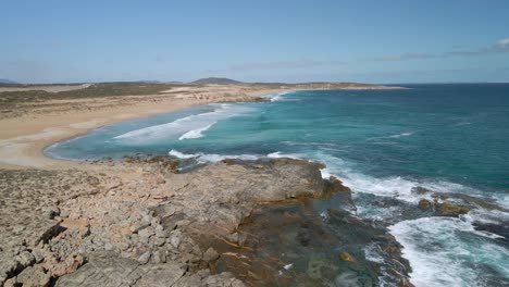 Greenly-Beach-wide-aerial-shot-with-rocky-coastline-and-beautiful-empty-sandy-bay,-Eyre-Peninsula,-South-Australia