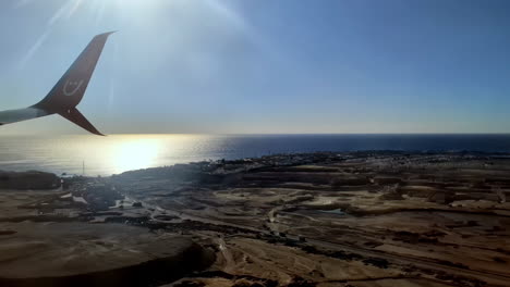 Modern-airliner-landing-in-exotic-area,-view-from-window