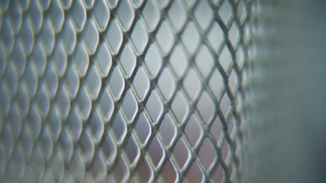 A-hyper-macro-shot-of-a-metal-grid,-steel-pattern,-iron-industrial-texture,-aluminum-material,-super-slow-motion,-Full-HD-120-fps,-tilt-up-smooth-movement
