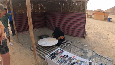 Tourists-Watching-Woman-Making-A-Traditional-Bedouin-Bread