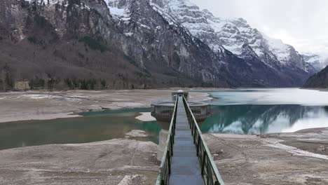 Klöntalersee\'s-Dam-With-Vorderglärnisch-Reflection,-Switzerland---Aerial