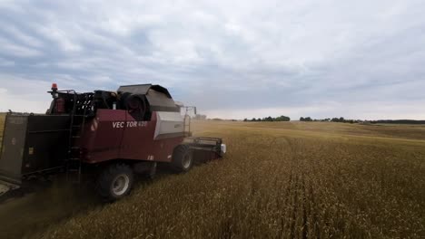 Drone-Shot-of-Modern-Grain-Harvester-Harvesting-Wheat-in-Norwegian-Agricultural-Field