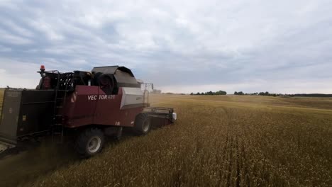 Toma-De-Drones-De-Una-Moderna-Cosechadora-De-Granos-Cosechando-Trigo-En-Un-Campo-Agrícola-Noruego