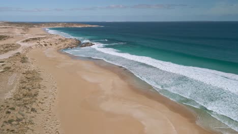 Stunning-aerial-view-of-empty-remote-Eyre-Peninsula-surf-beach-with-yellow-sand-and-turquoise-water,-Greenly-Beach,-South-Australia