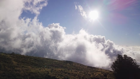 Drone-dolly-view-over-the-Haleakala-volcano-while-white-clouds-moving-over-a-valley-on-Maui,-Hawaii