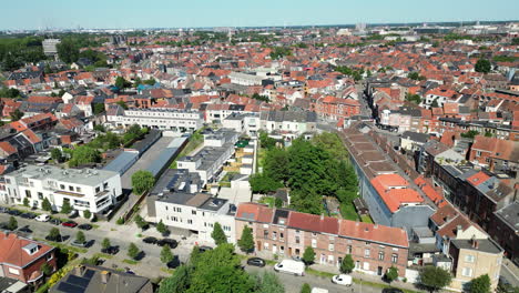Moving-Down-Aerial-on-Ghent-Outskirts-Cityscape-With-Numerous-Buildings