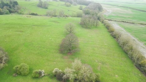 Drone-view-of-field-beside-Rockingham-Church-in-Northamptonshire,-England