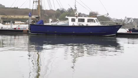 Fishing-boats-moored-in-marina-West-Cork,-due-to-bed-weather,-calm-waters-and-grey-skies-in-rural-Ireland