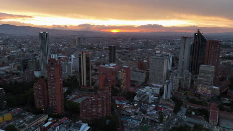 Aerial-tracking-shot-of-downtown-Bogota,-moody-sunset-with-clouds-in-Colombia