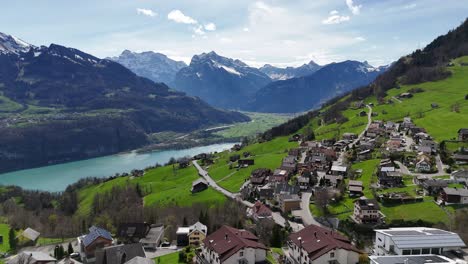 Aerial-establishing-shot-of-idyllic-swiss-village-named-Amden-during-sunny-day