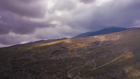 Crepuscular-rays-distinguish-through-cloudburst,-timelapse-of-Malaga-mountainside