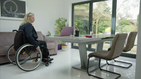 Woman-in-wheelchair-entering-home-office-wide