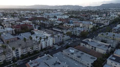 Push-in-drone-shot-across-dense-urban-neighborhood-in-Los-Angeles-during-golden-hour