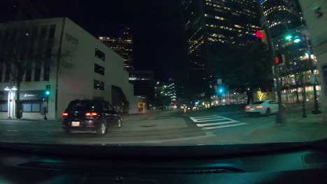 Series-number-five-hyperlapse-showing-car-driving-through-downtown-Dallas-Texas-at-night-with-city-lights-and-some-Christmas-lights,-stop-lights,-and-many-turns