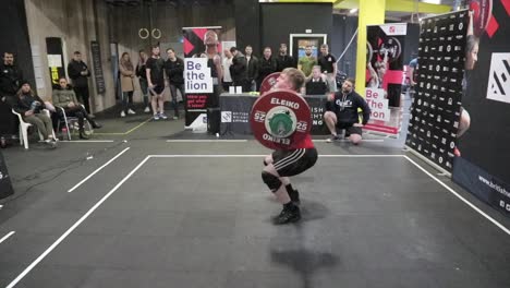 Male-athlete-performing-a-clean-and-jerk-in-slow-motion-side-view