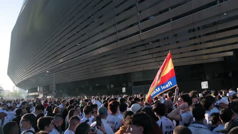 Un-Fan-Sostiene-Una-Bandera-Española-Con-Un-Emblema-Del-Real-Madrid-Mientras-Una-Gran-Multitud-Asiste-Al-Partido-De-Fútbol-De-La-Liga-De-Campeones-Los-Equipos-Español-Y-Británico-Real-Madrid-Y-Manchester-City-En-El-Estadio-Santiago-Bernabeu