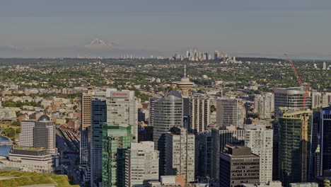 Vancouver-BC-Canada-Aerial-v47-zoomed-drone-flyover-downtown-metropolitan-area-capturing-urban-cityscape-with-dense-skyscrapers,-views-of-Burnaby-and-mountain---Shot-with-Mavic-3-Pro-Cine---July-2023