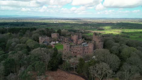 Peckforton-Castle-historic-landmark-in-the-springtime---aerial-drone-nearby-approach---Cheshire,-England,-UK