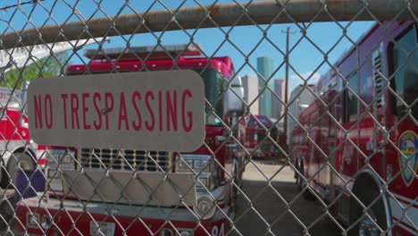 Establishing-shots-of-yard-full-of-disabled-fire-trucks-with-downtown-Houston-in-the-background