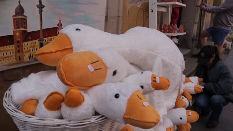 A-street-vendor-sells-adorable-duck-plush-toys-in-the-heart-of-Warsaw,-Poland,-capturing-the-essence-of-whimsy-and-joy