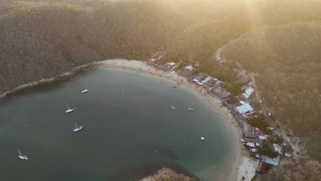 Beach-surrounded-by-mountains-drone-view,-Maguey-Bay,-Huatulco,-Oaxaca,-Mexico