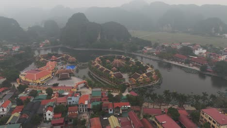 Aerial-Drone-Shot-of-Vietnam-Lake-Surrounded-By-Lake-and-Buildings