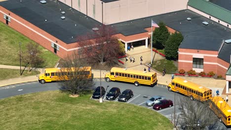 Student-and-Pupils-running-to-yellow-school-bus-after-finishing-lesson