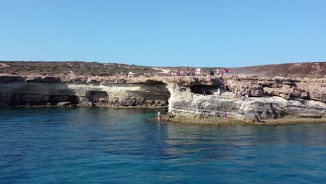 People-Exploring-and-Enjoying-Sea-Caves-Coastal-Front-of-Ayia-Napa,-Cyprus