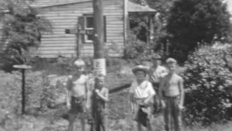 Poor-Children-Stand-in-Front-of-a-House-in-a-Rural-Roadside-Area-in-Summertime