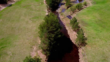 Flying-Above-Creek-and-Green-Pastures,-Vodice-Village,-Zlatibor-Mountain,-Serbia