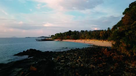 4K-Cinematic-nature-drone-footage-of-a-panoramic-aerial-view-of-the-beautiful-beaches-and-mountains-on-the-island-of-Koh-Lanta-in-Krabi,-South-Thailand,-during-sunset