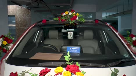 A-glimpse-of-a-classic-wedding-car-adorned-with-vibrant-fresh-flowers-for-a-traditional-wedding-ceremony