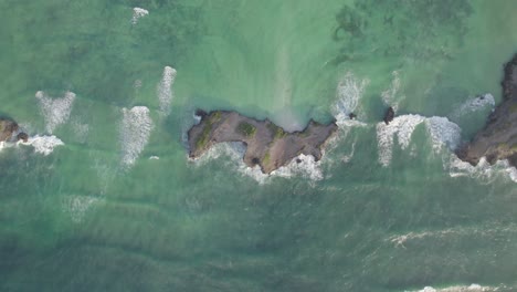 Aerial-view-of-water-waves-surround-Island,-Kenyan-Coast