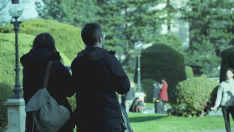 Slow-Motion-Shot-Of-Couple-Taking-Pictures-In-Maria-Theresien-Plaza,-Vienna,-Austria