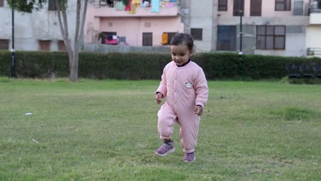 cute-indian-toddler-walking-in-jumpsuit-at-outdoor-from-different-angle