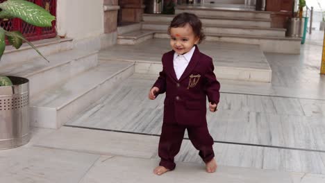 cute-indian-toddler-walking-in-suit-at-outdoor-from-different-angle