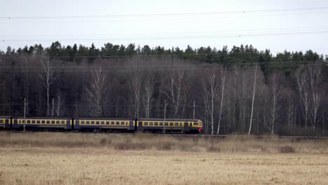 aerial-following-train-riga-jurmala-crossing-babite-Latvia-north-europe-forest-elecrical-lines