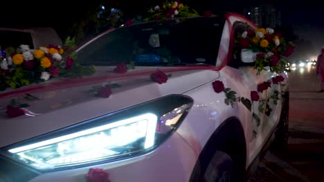 The-scene-shows-a-classic-wedding-car-adorned-with-fresh-flowers-for-the-bride-and-groom's-special-day