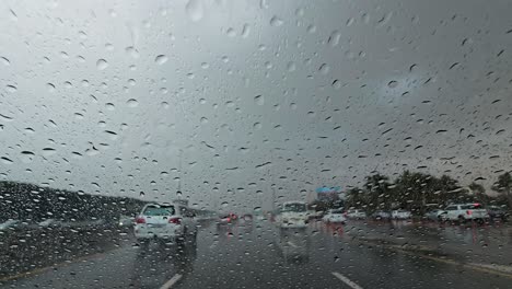 Heavy-rain-in-the-UAE:-A-view-from-the-car-dashcam-capturing-rainfall-in-Dubai,-United-Arab-Emirates